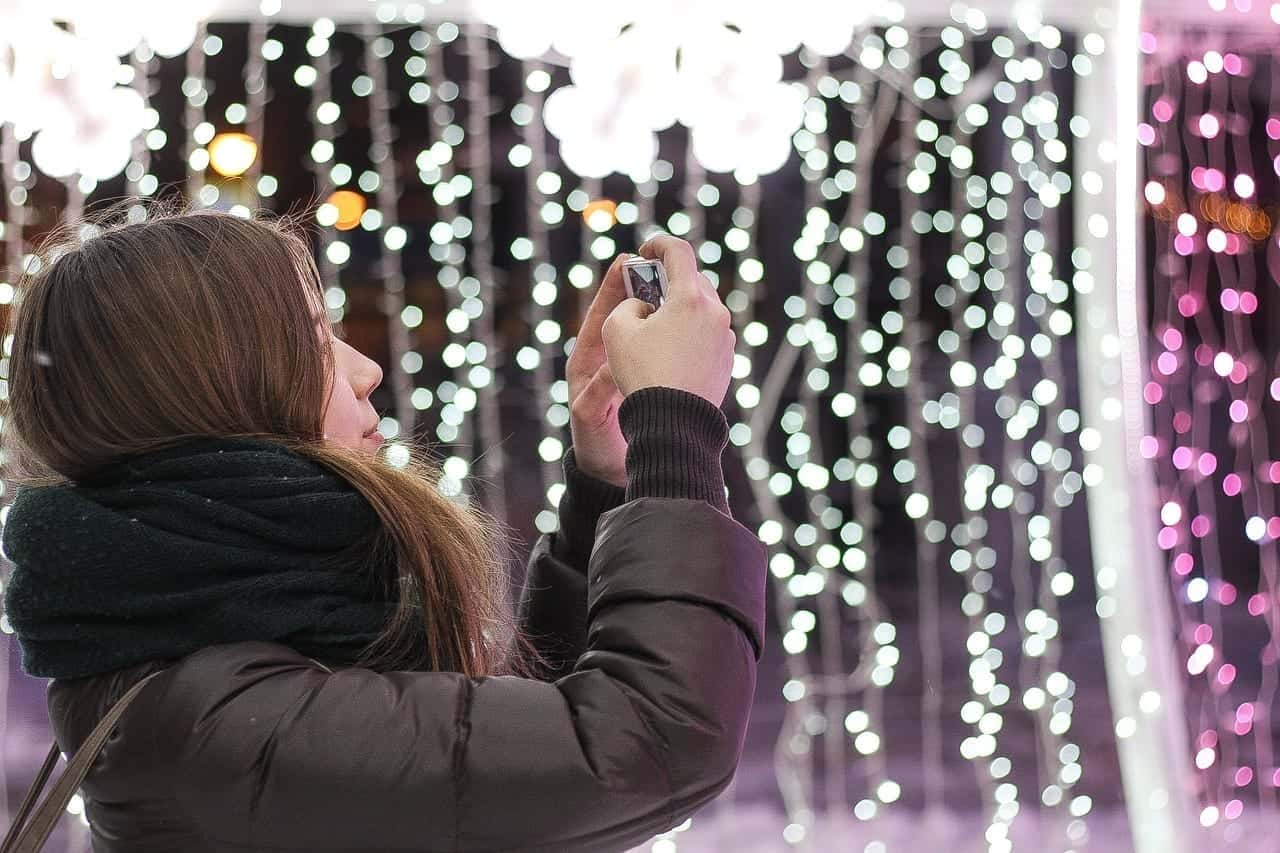 woman takes picture of lights experiential marketing